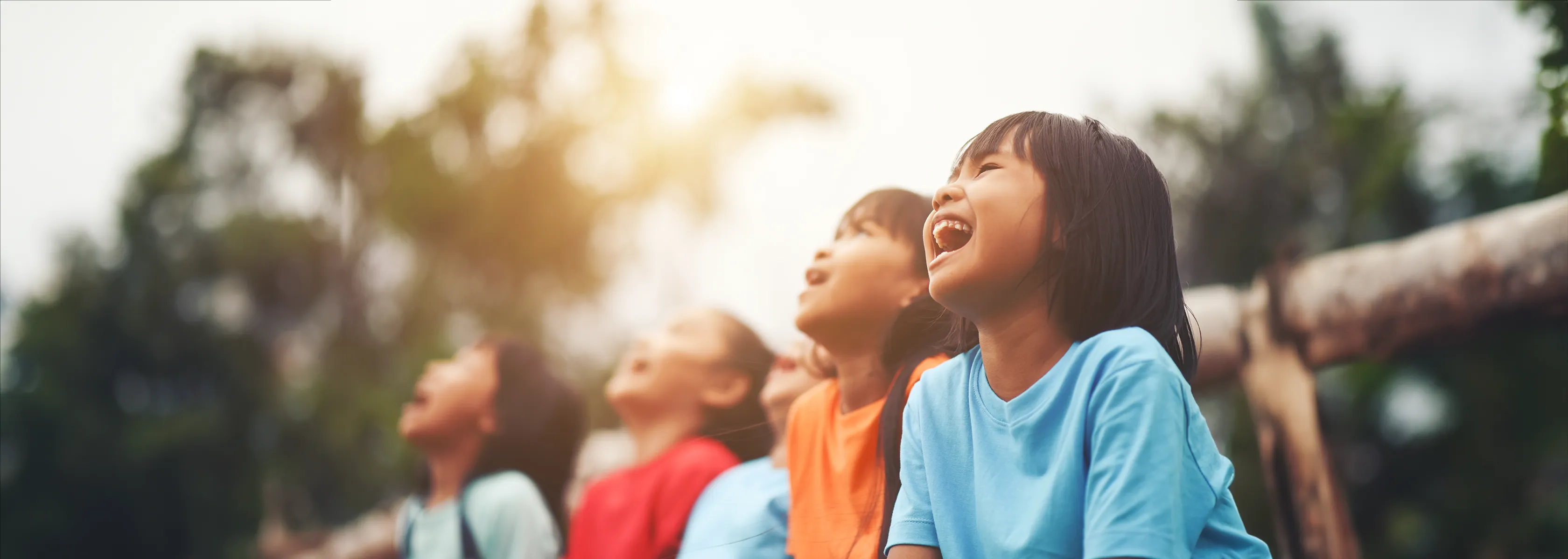 Children smiling outdoors, representing autism awareness