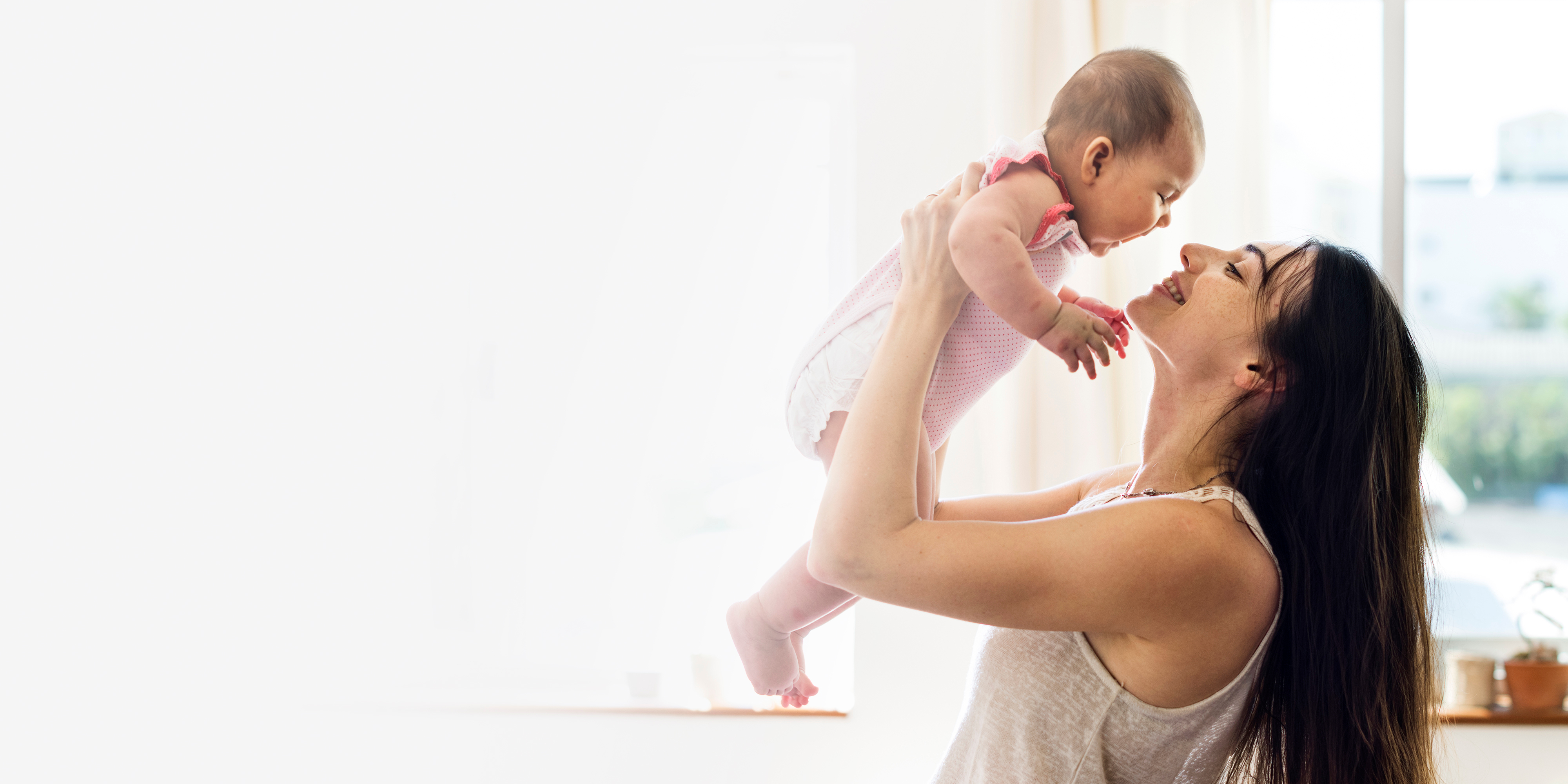 young-mom-holding-her-baby-air-blank-space