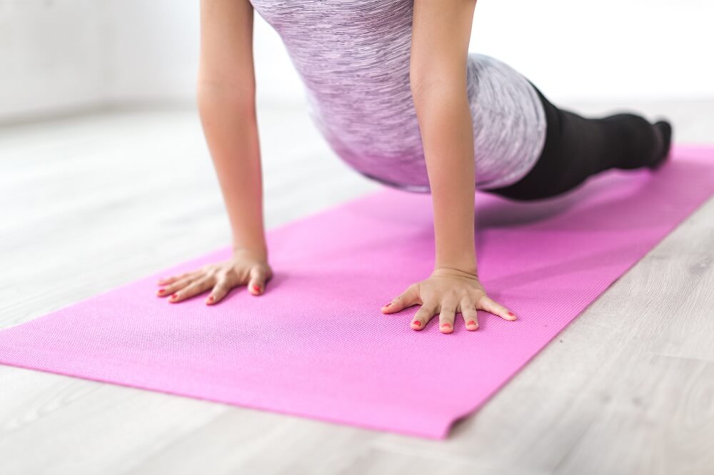 Woman practicing yoga for managing ovarian cyst symptoms