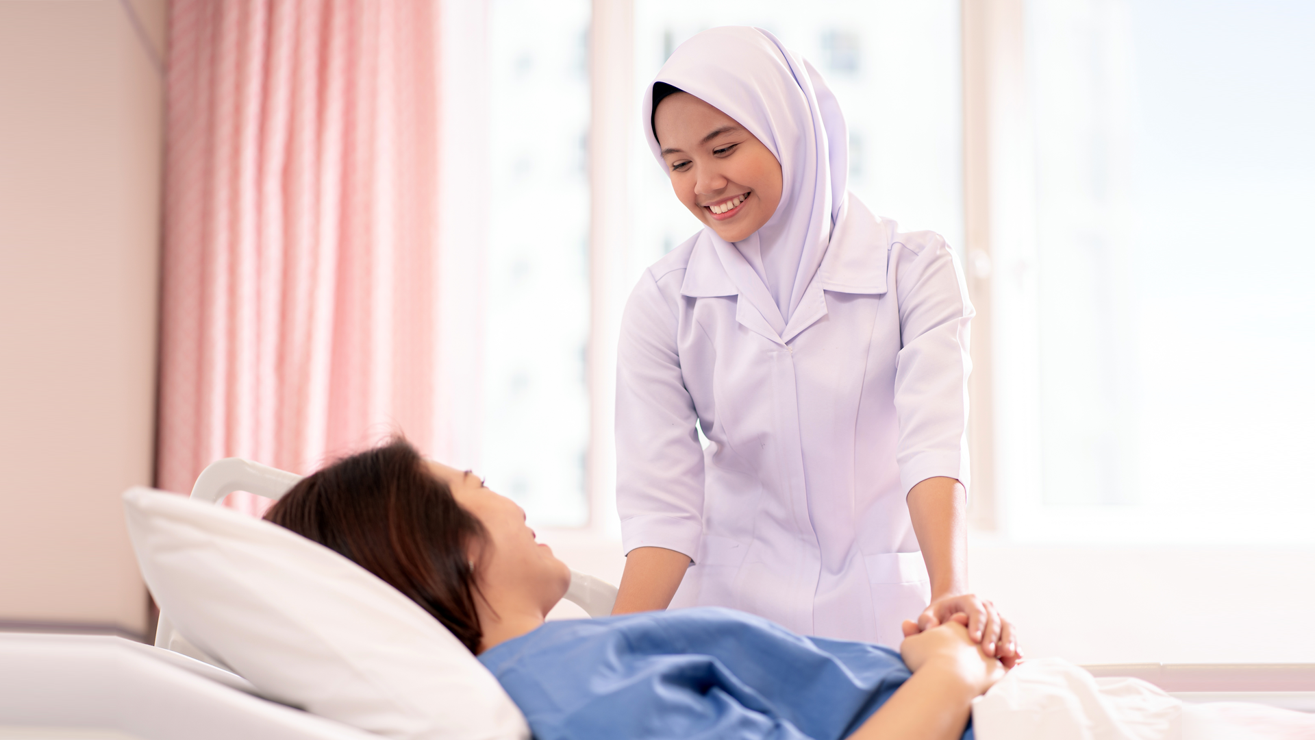 Nurse comforting a cancer patient in a hospital room