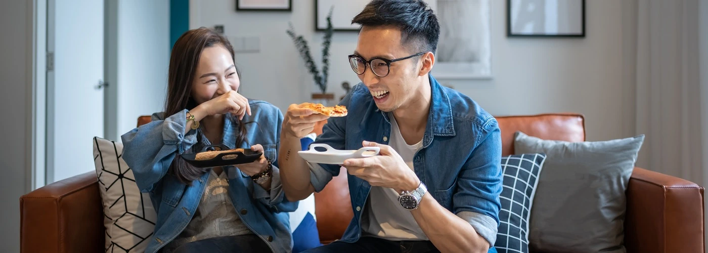 Two friends enjoying a meal, symbolizing healthy digestion and comfort in eating