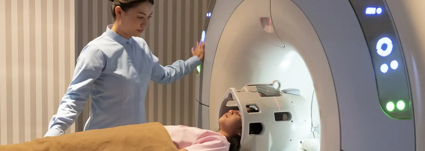 A radiographer preparing a patient for a radiotherapy session.