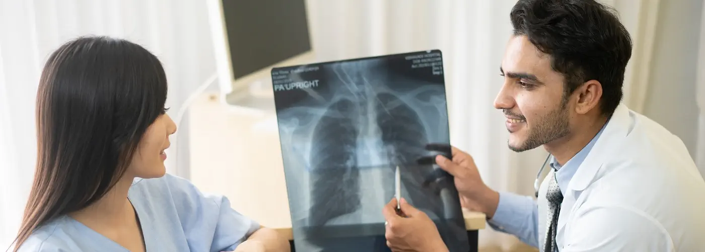 Doctor reviewing a chest X-ray with a patient